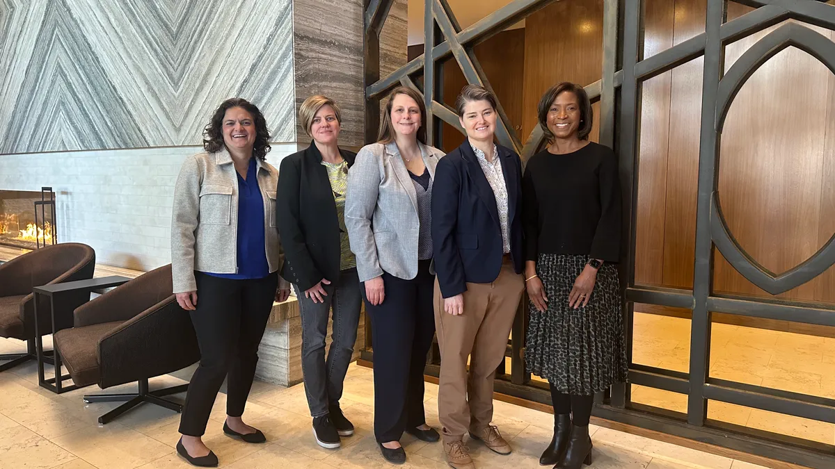 Five women, the heads of the Chicago offices of AECOM-Hunt, Gilbane, Mortenson, Turner and Powers & Sons, pose for a group photograph.