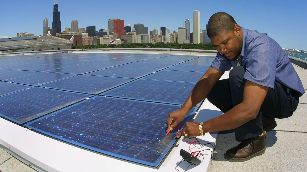 Building engineer Ernst Loubeau performs a diagnostic maintenance procedure on the solar electric system located on the roof of the Field Museum of Natural History in Chicago