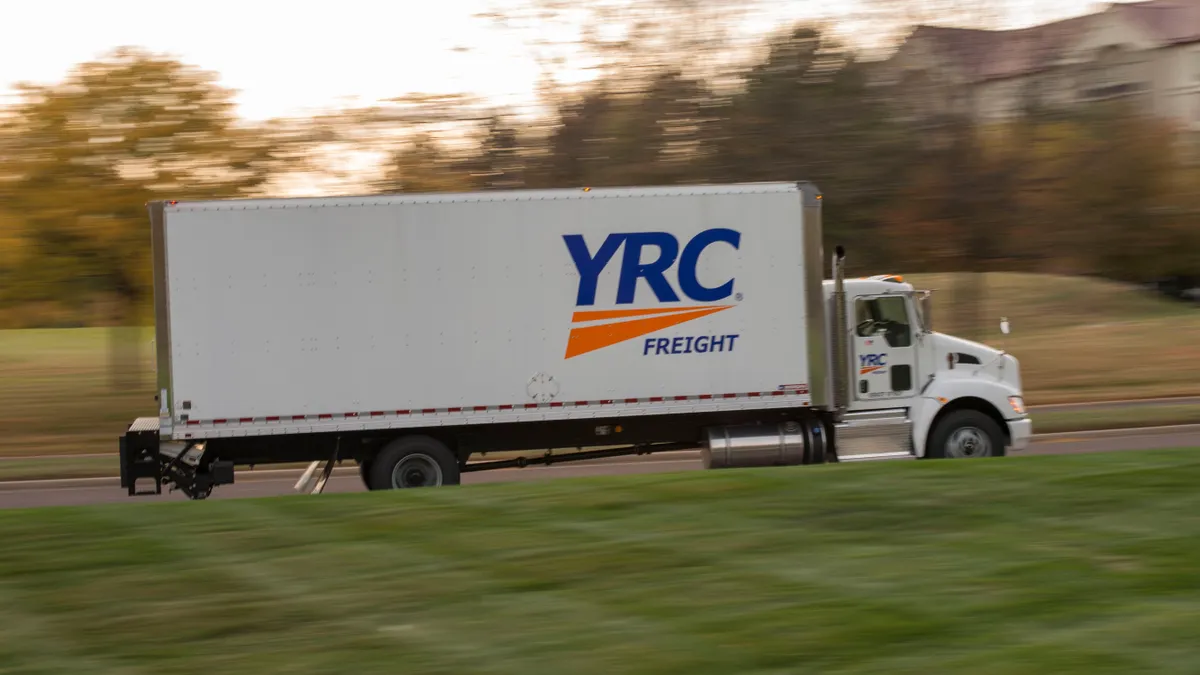 A YRC freight truck driving on a road.