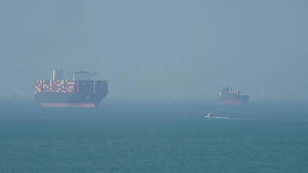 A wide shot of massive ships on the ocean.
