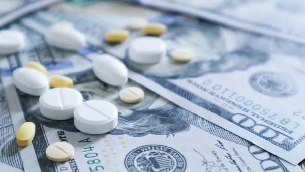 Medicine pill on 100 dollar banknote background