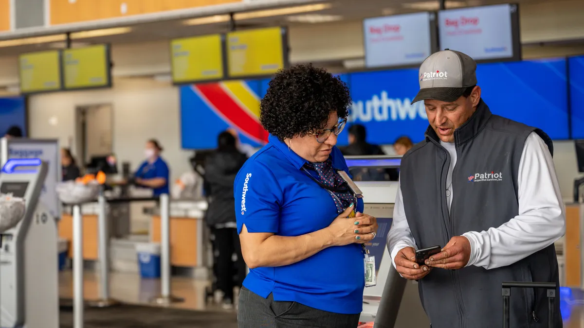 A Southwest Airlines employee assists a passenger during their check-in at the Austin-Bergstrom International Airport on April 18, 2023, in Austin, Texas.