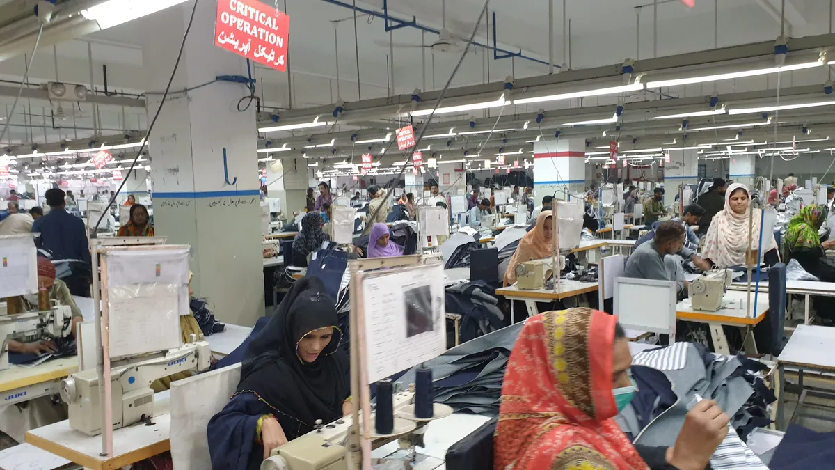 Garment works in a factory in Pakistan sew clothes.