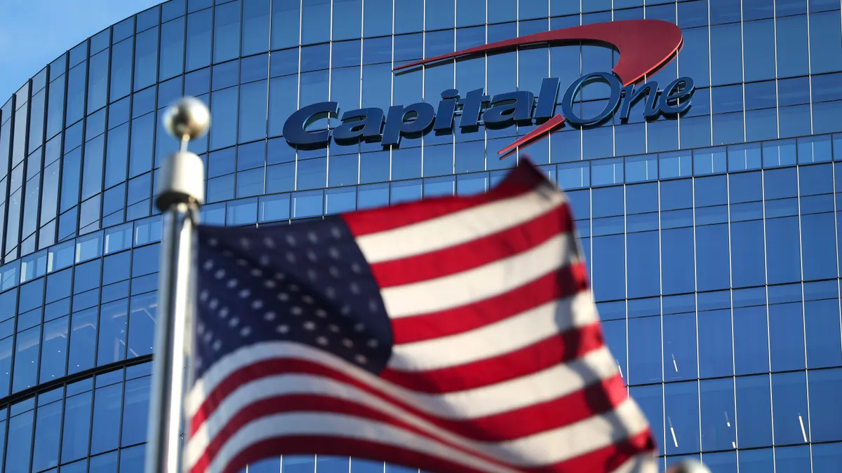 An American flag flies in front of the Capital One logo at the bank's headquarters.