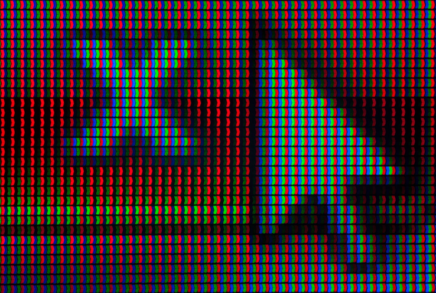 A close up of a cursor arrow hovering over an X on a screen, pixelated with red, blue and green colors.