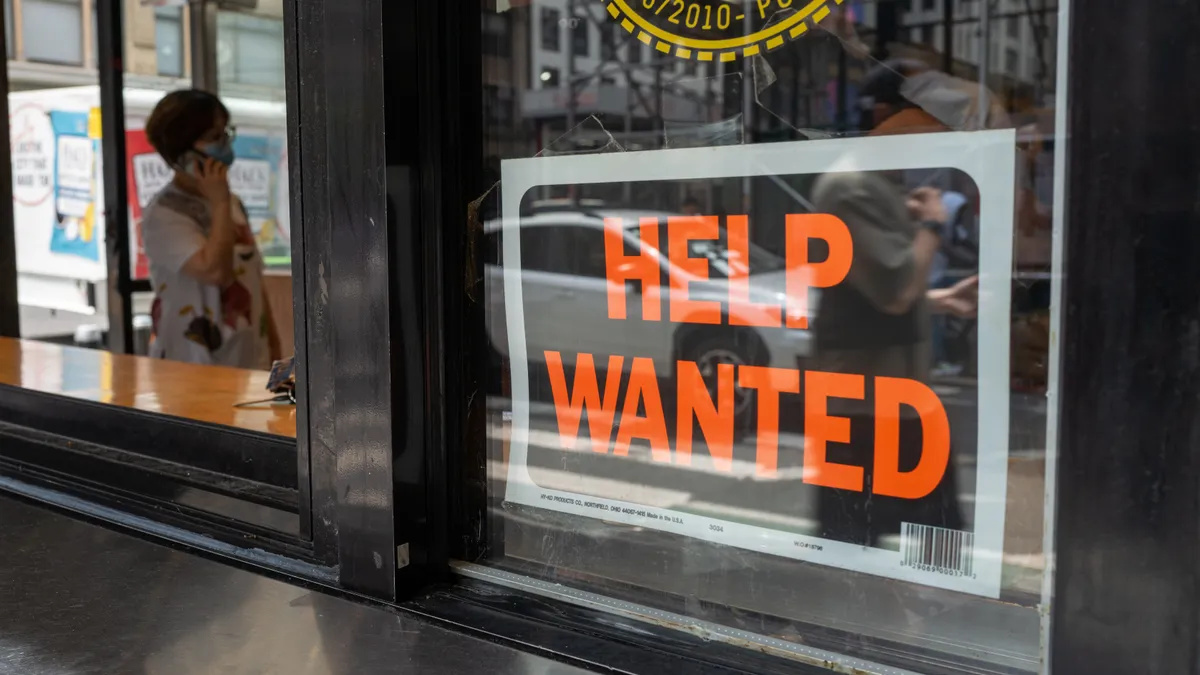 A business window features a "help wanted" sign.