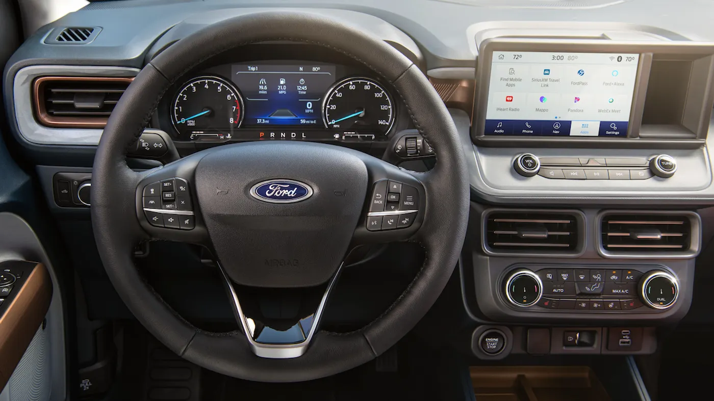 The driver side of a 2024 Ford Maverick pickup showing the steering wheel, instrument cluster and infotainment screen.
