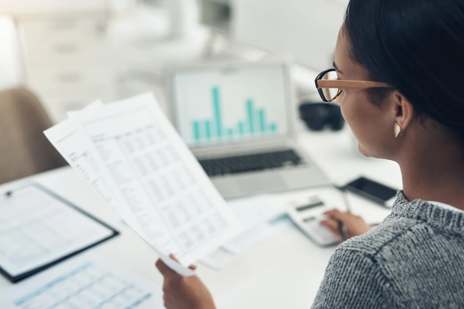 Closeup shot of a person calculating finances in an office