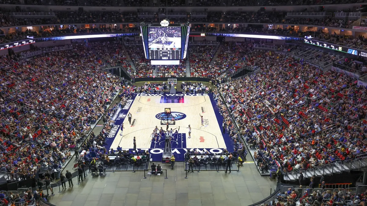 A photo of the interior of a sports arena during a basketball game.