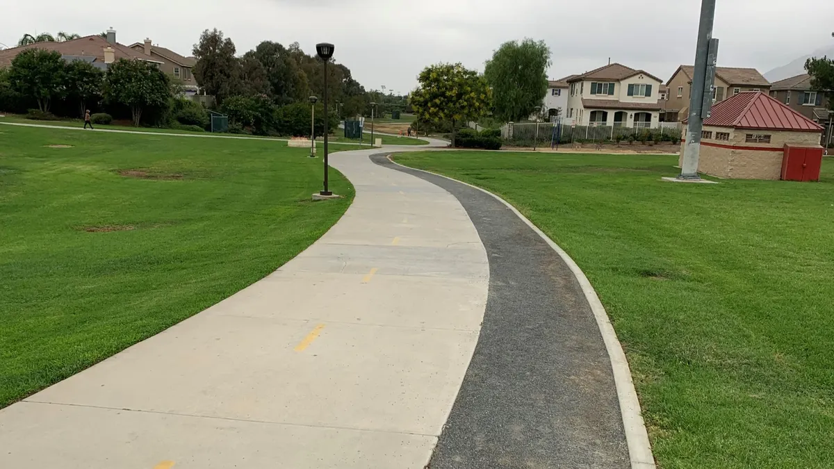 A trial cuts through a park area