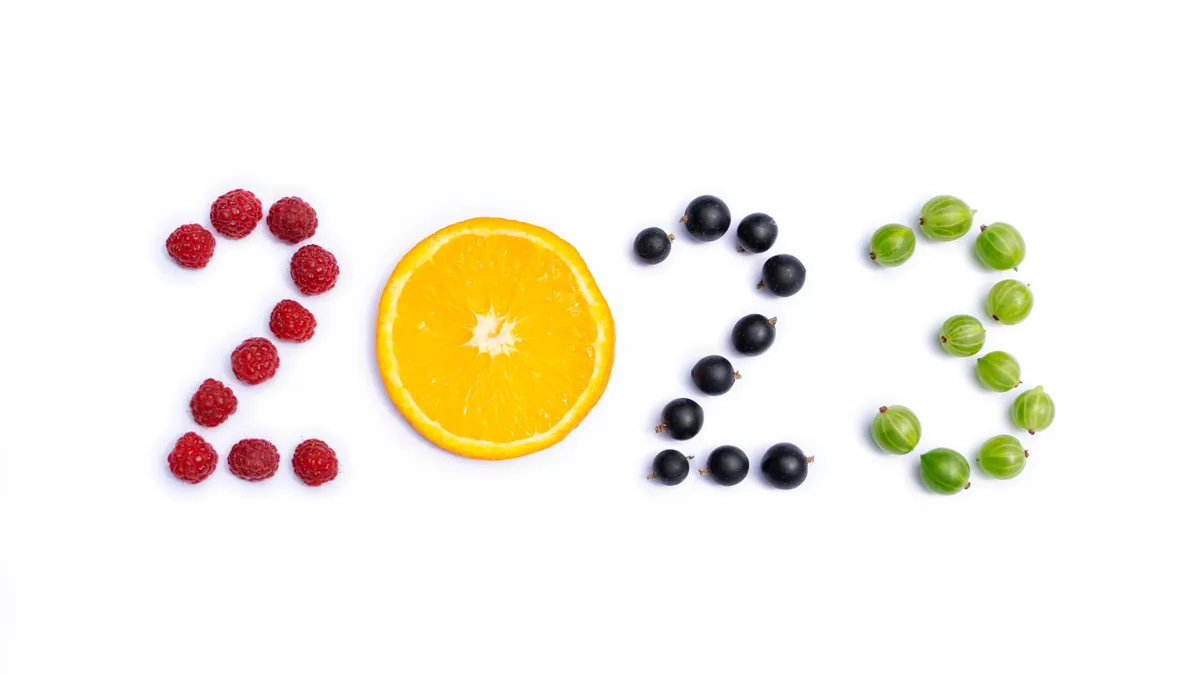 "2023" spelled out with berries on white background