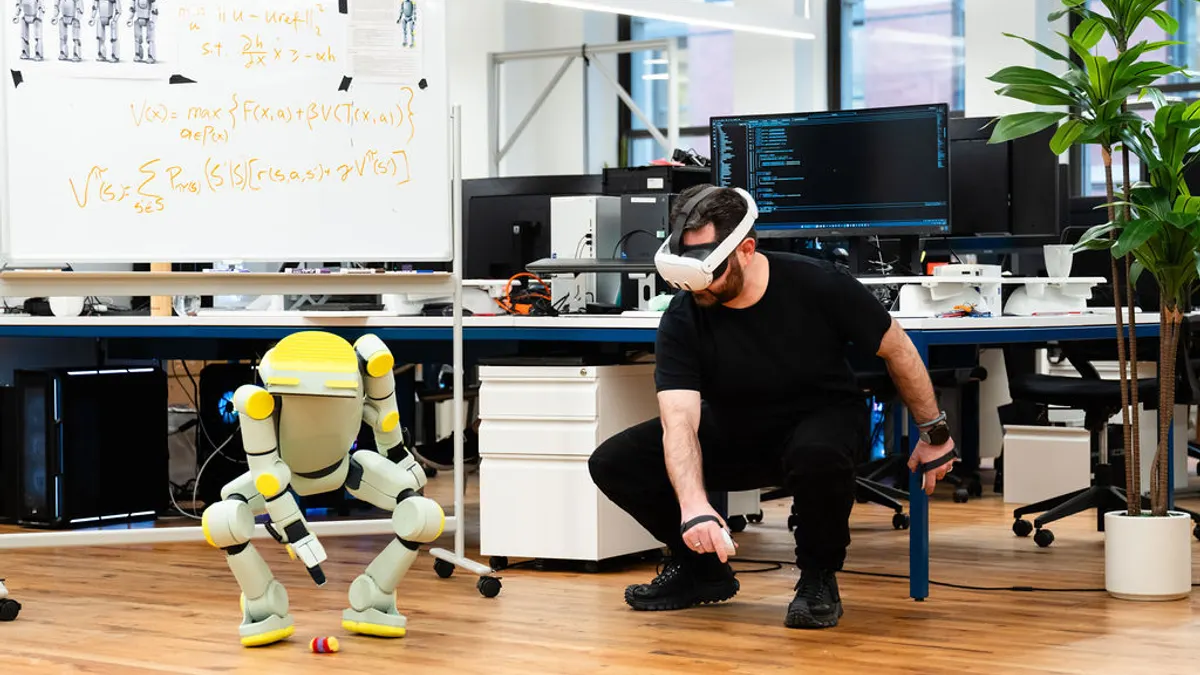 A Fauna Robotics employee trains its Sprout robot to pick up an object using a virtual reality headset.