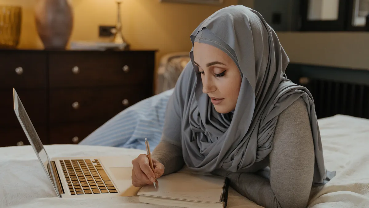 woman studying with laptop and notebook