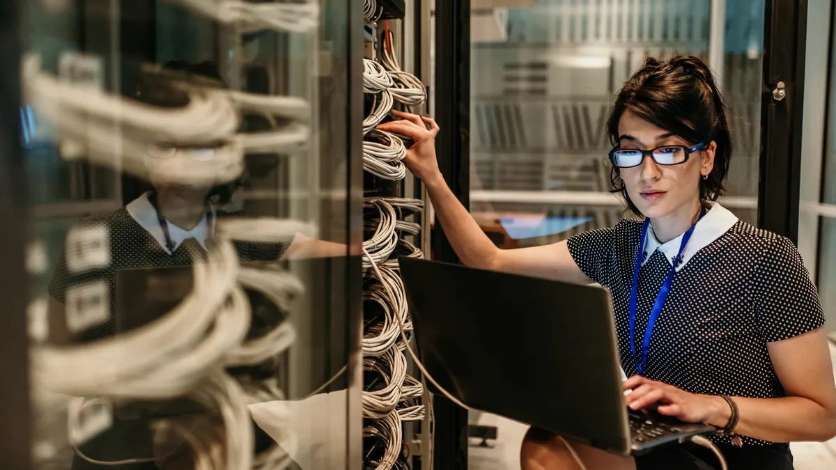 Engineer in network server room.