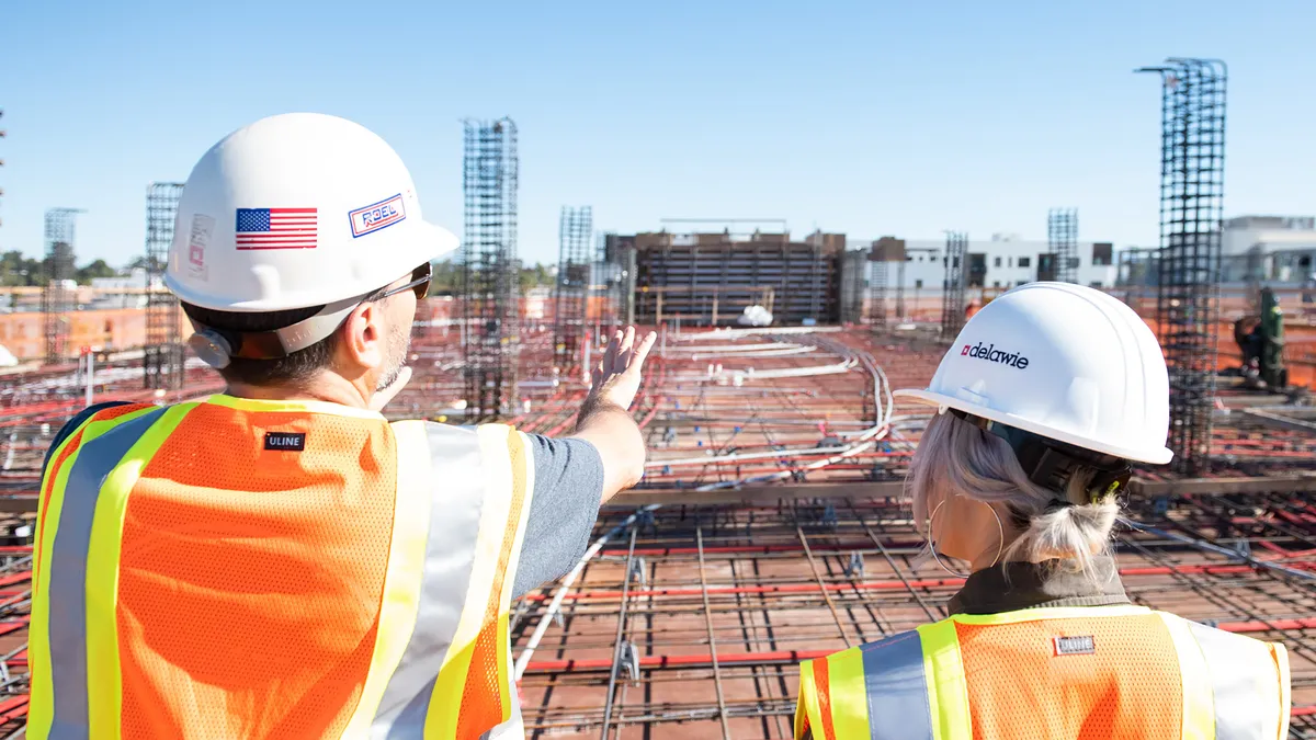 Contractors in work vest oversee worksite