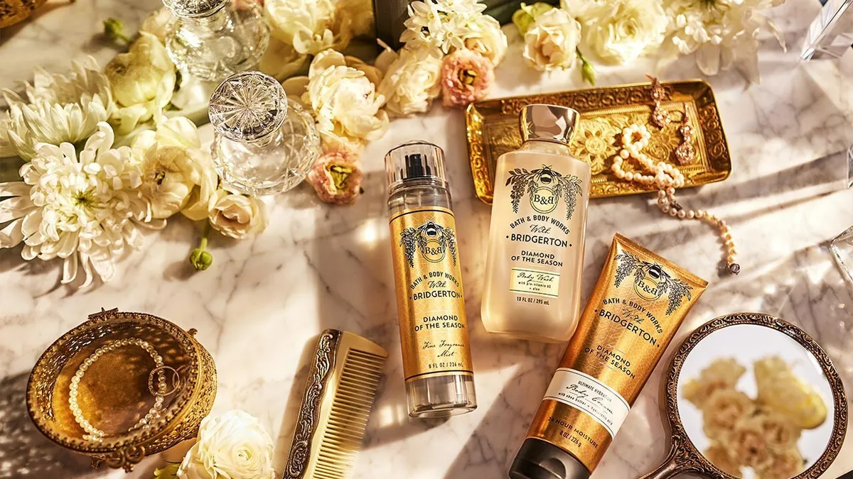 A selection of gold-colored bottles on a marble backdrop.