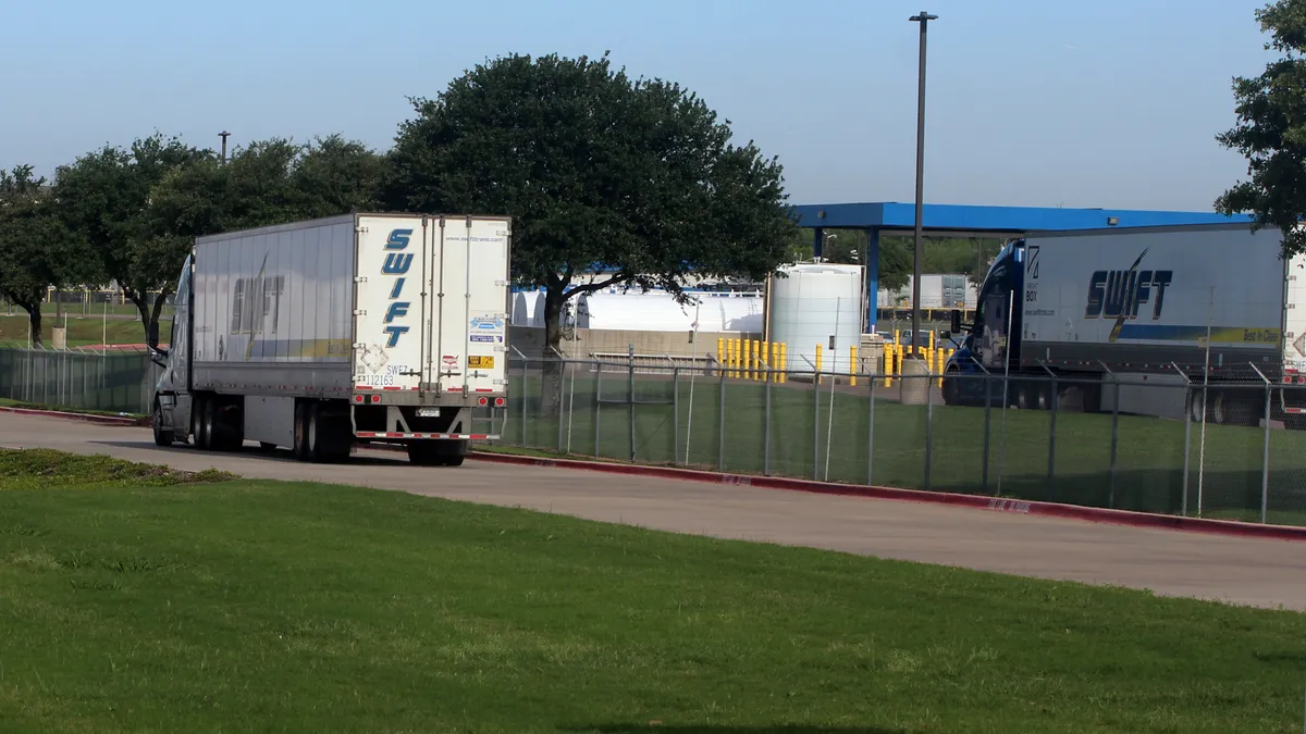 A Swift Transportation tractor-trailer drives down a road next to the company's Lancaster, Texas, terminal.