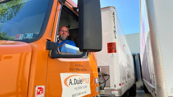 A. Duie Pyle driver Jesse Weeks backs his truck up to a customer dock on May 1, 2024.