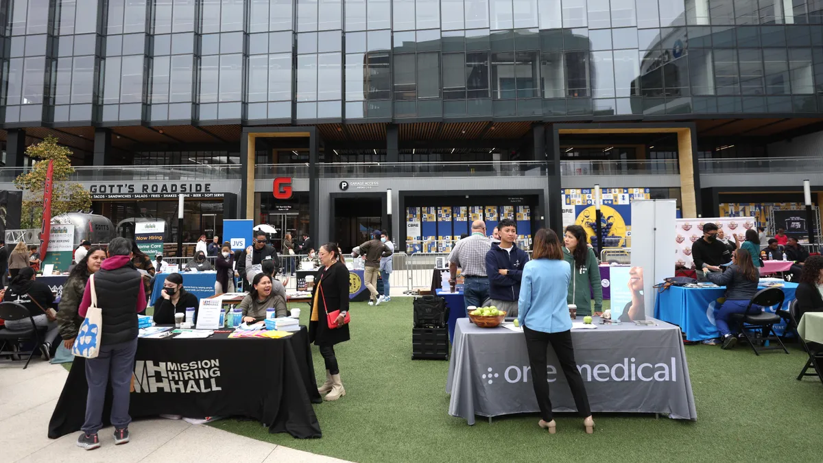 Job seekers meet with recruiters during a career and training fair.