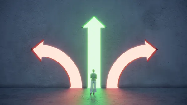 Woman standing in front of different colored arrow shaped portals.