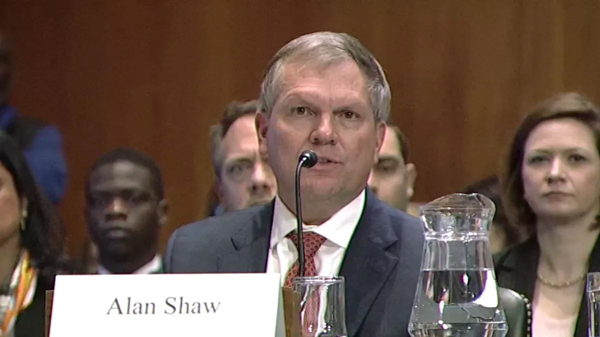 Alan Shaw speaks into a microphone during a Senate hearing