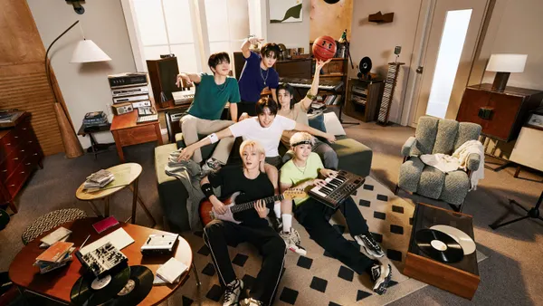 A group of people in Under Armour clothes sit in a living room.