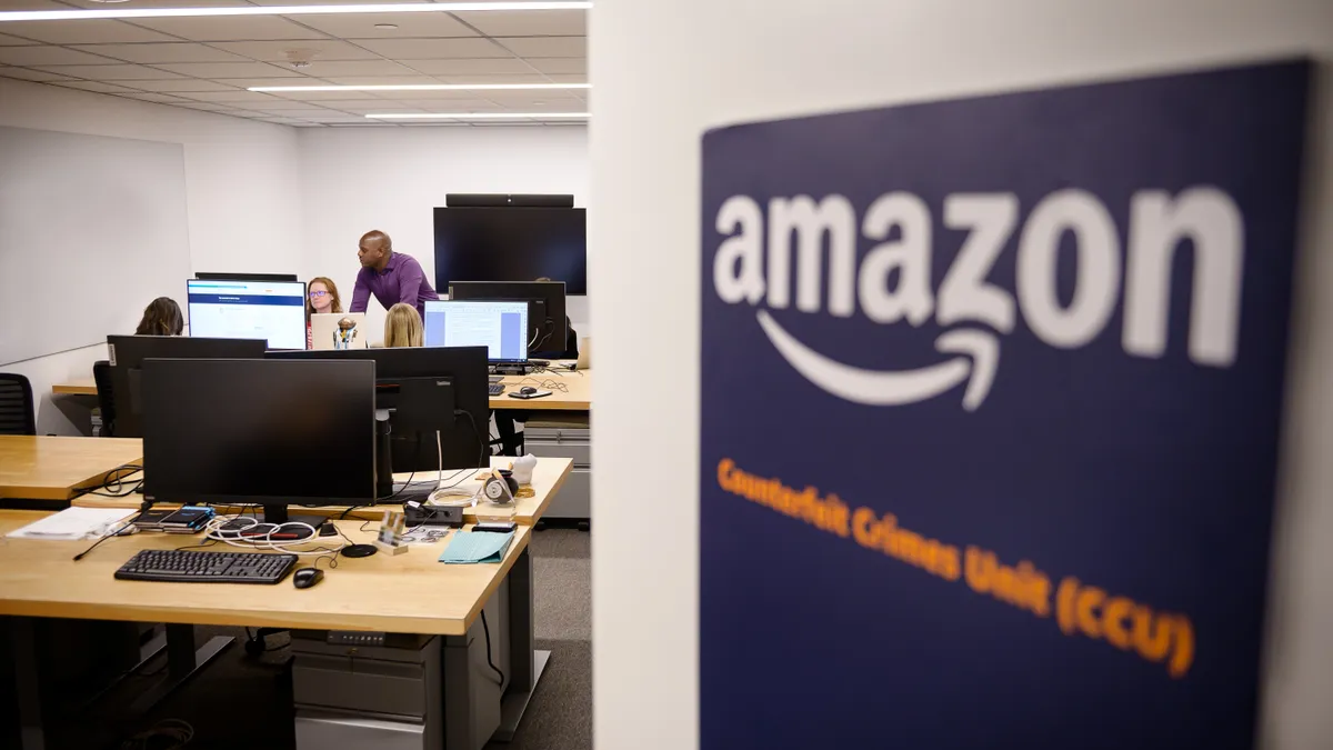 People on the Amazon CCU team are seen working on computers in an office space.