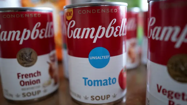 A closeup of three cans of Campbell's soup.