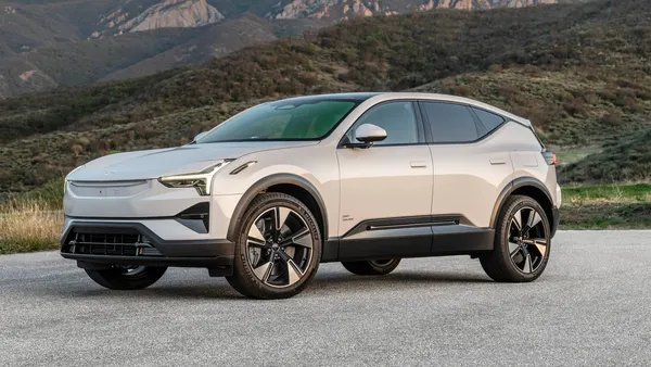 A white Polestar 3 long-range electric SUV parked outdoors with mountains in the background.