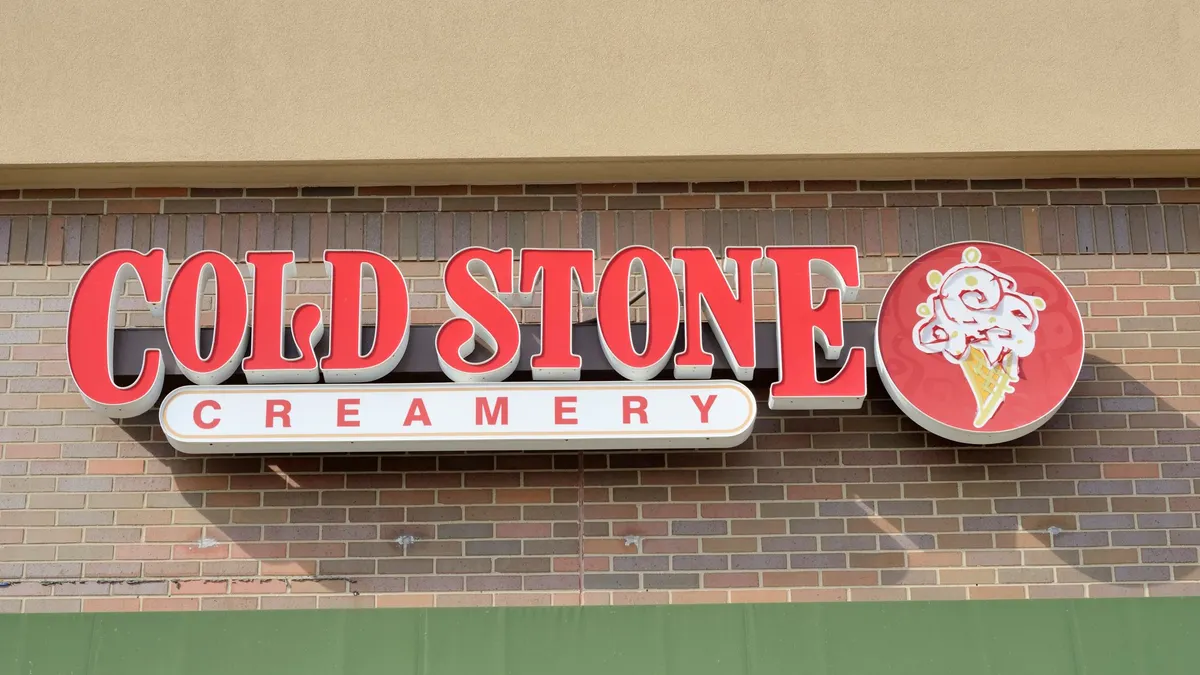 A image of a sign in red that says Cold Stone Creamery.