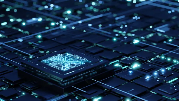 Futuristic central processor unit on the abstract motherboard with blue lights and rays as symbol of data transfers.