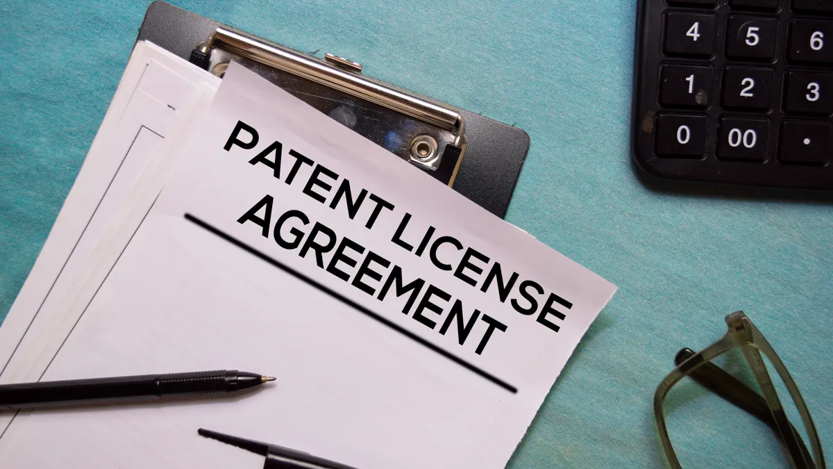 Patent Licence Agreement text on Document form isolated on office desk.