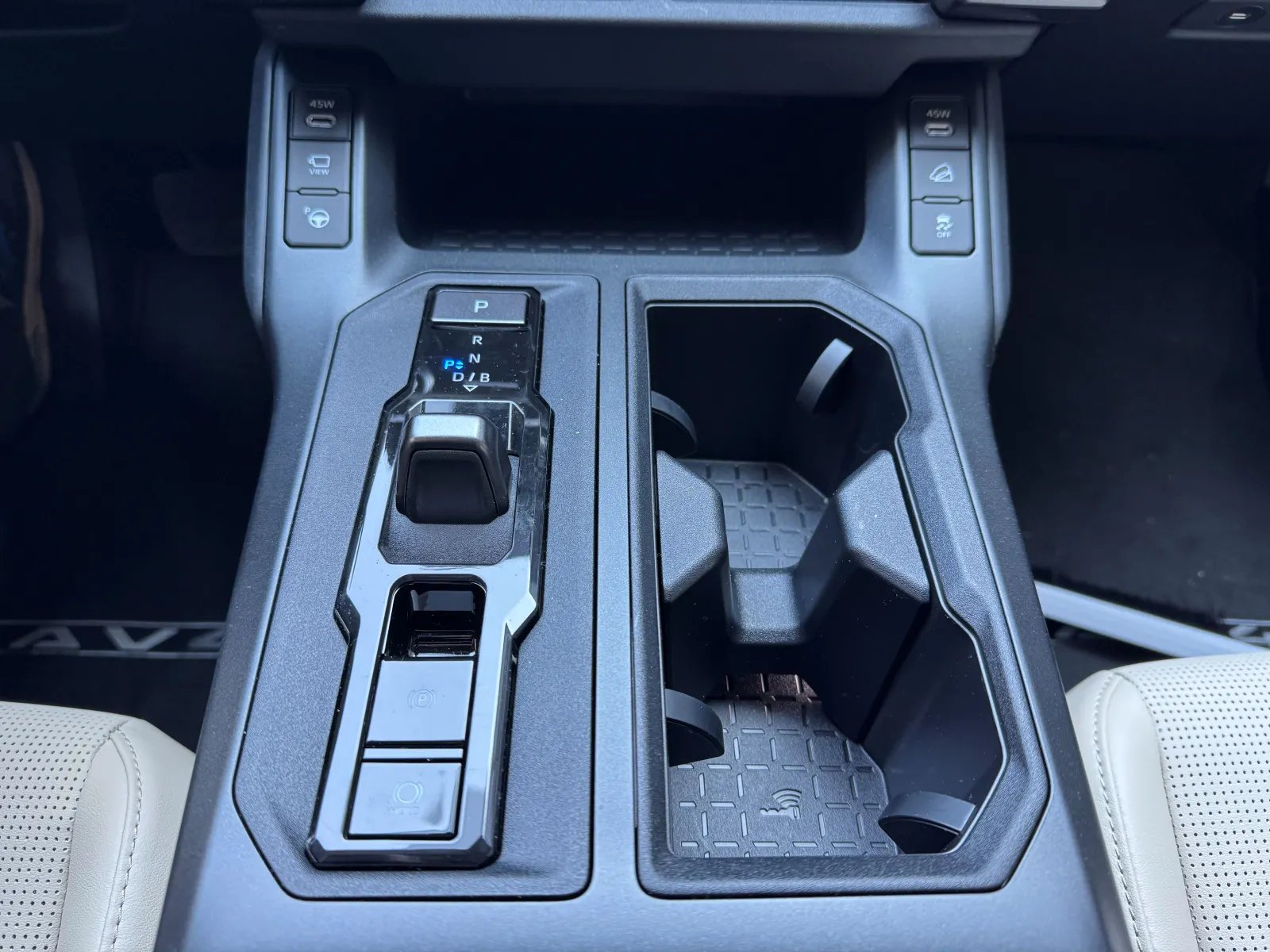 The small toggle shifter on the Toyota 2026 RAV4 Limited handles shifting duties and allows a place for the advanced park functions.