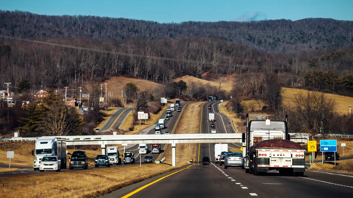 Passenger cars and trucks on two directions of a highway in Virginia.