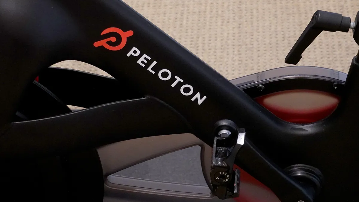 A zoomed in view of a Peloton bike with the logo visible in red.