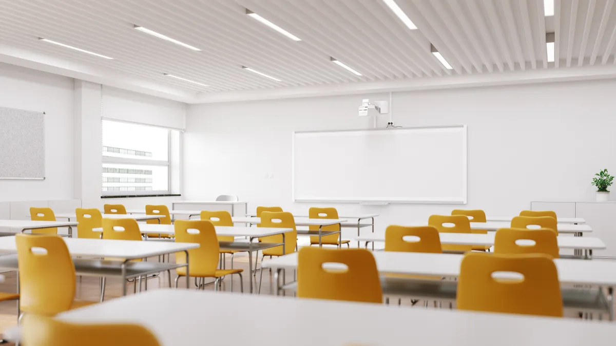 Rows of empty chairs in a modern-looking classroom.