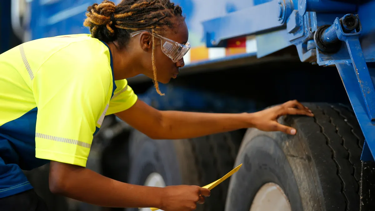 A student works on a collection vehicle at the Republic Services Technical Institute in Dallas, Texas, on Monday, Oct. 4, 2021.