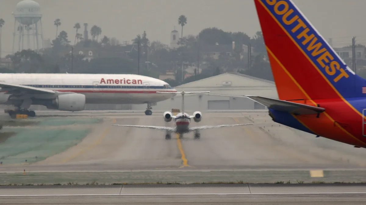 American Airlines and Southwest Airlines jets on the runway at Los Angeles International Airport.