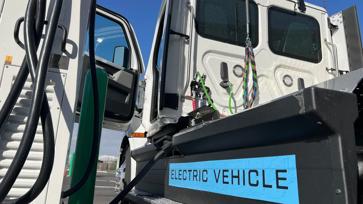 A white EV semi truck charges at Forum Mobility's FM Harbor charging station in Long Beach, California.