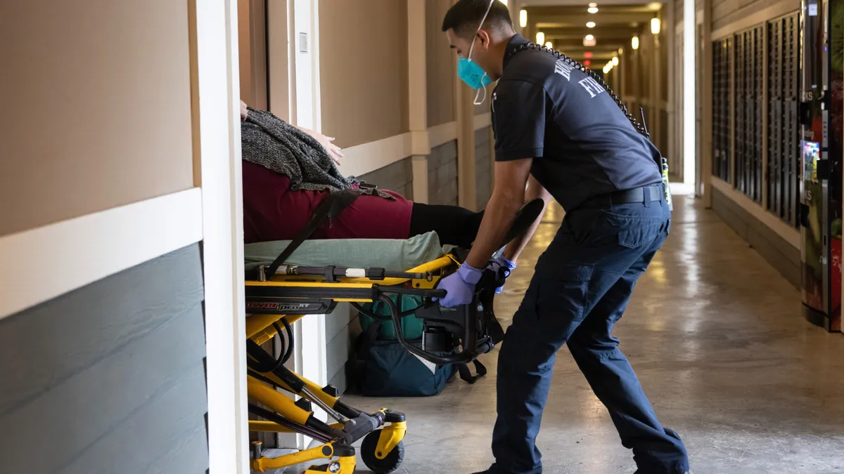 A paramedic wheels transports a patient.