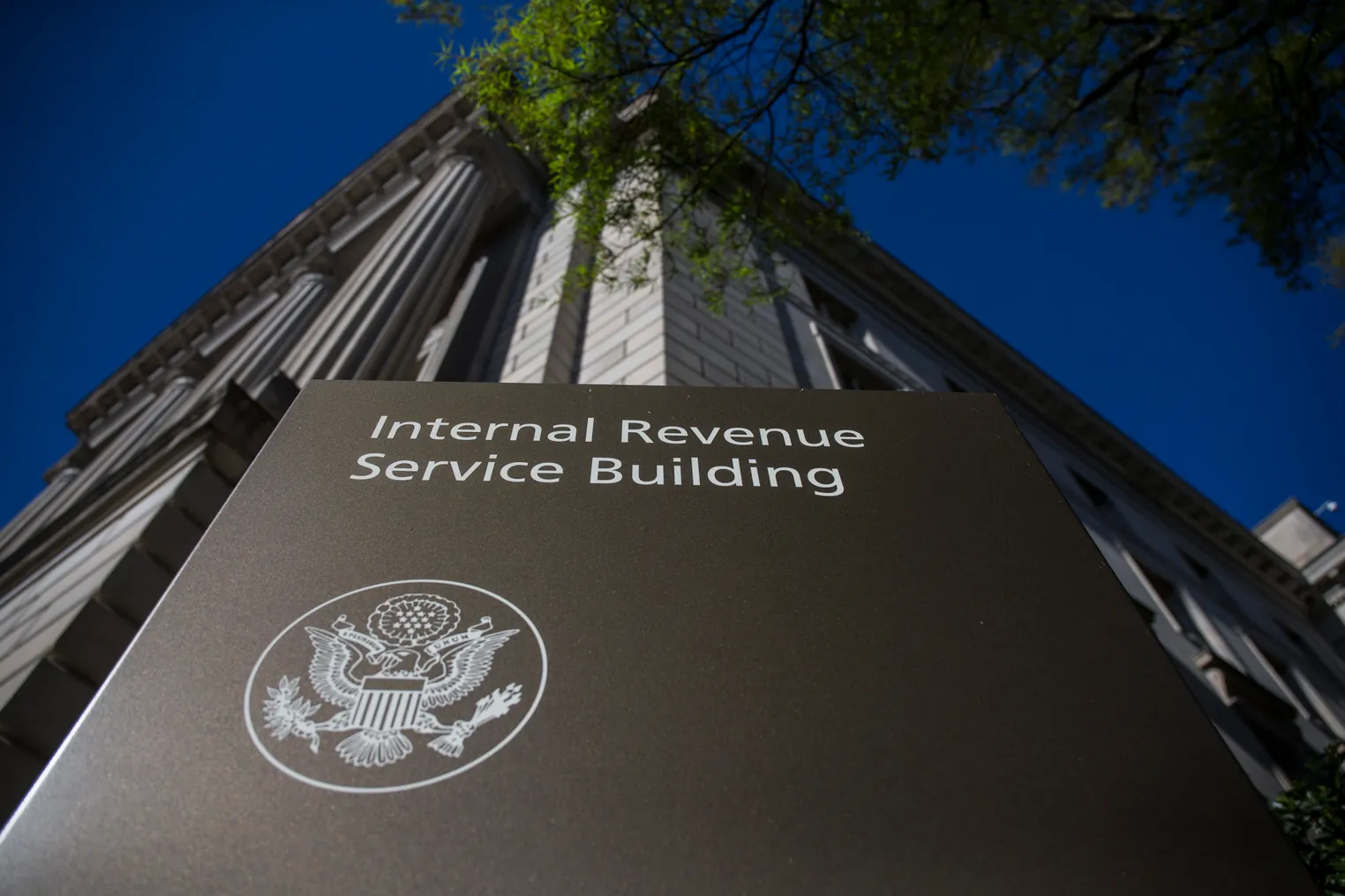 A sign that says "Internal Revenue Service Building" is seen in front of the agency's building.