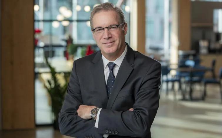 Chris Spear, president and CEO of the American Trucking Associations, smiles with his arms folded in an ATA-provided headshot.