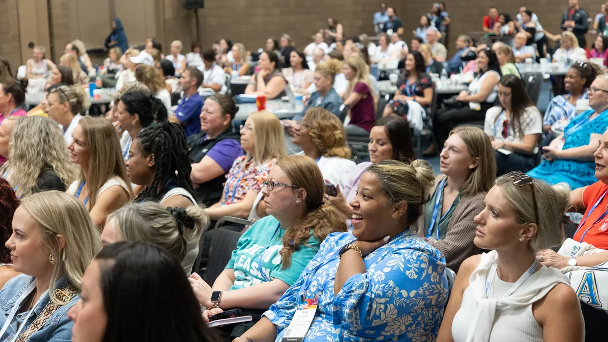 Attendees listen at a conference.