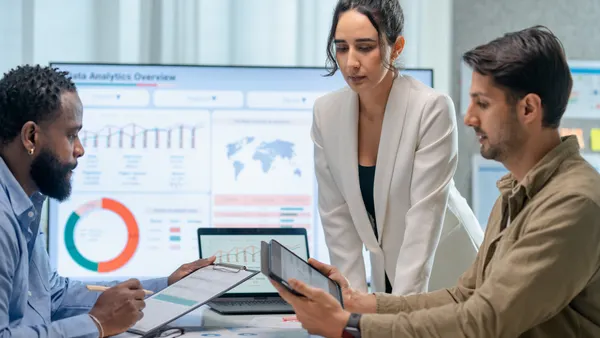 Increase credibility and Trust in communication to build Powerful Relationships. Business teamwork presented to their customer in a board room. They are discussing a business project over info-graphic data on a screen in a business office.