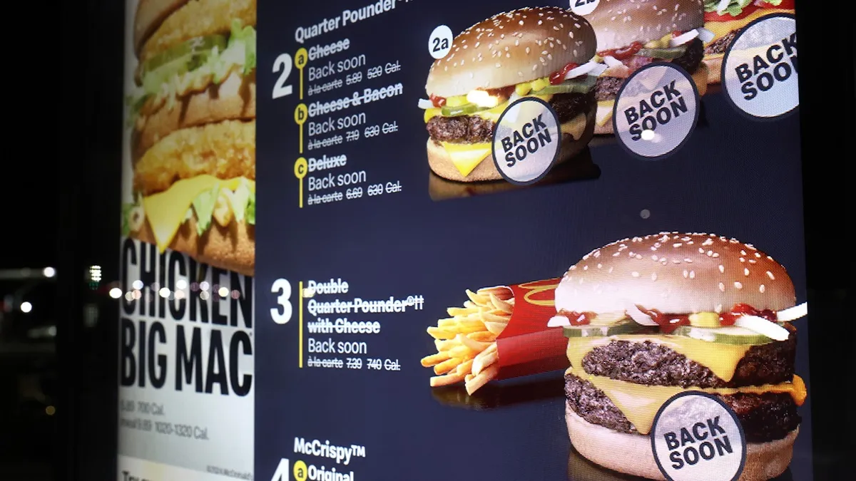 An image of a menu board from McDonald's showing quarter pounders crossed off and words that say "back soon."