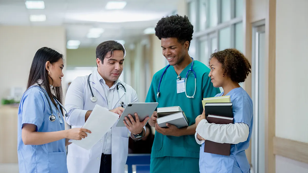 A group of doctors and nurses standing in a hospital hallway, ready to provide medical care.