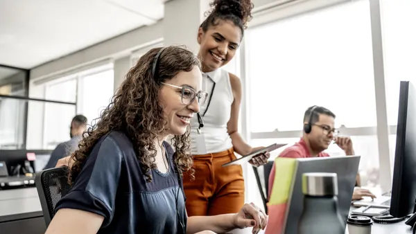 Call center manager instructing employees.