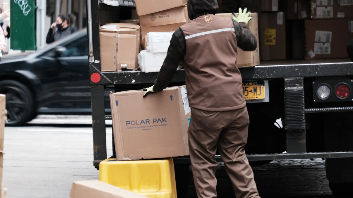 A UPS worker delivers boxes in Manhattan on April 26, 2022 in New York City.