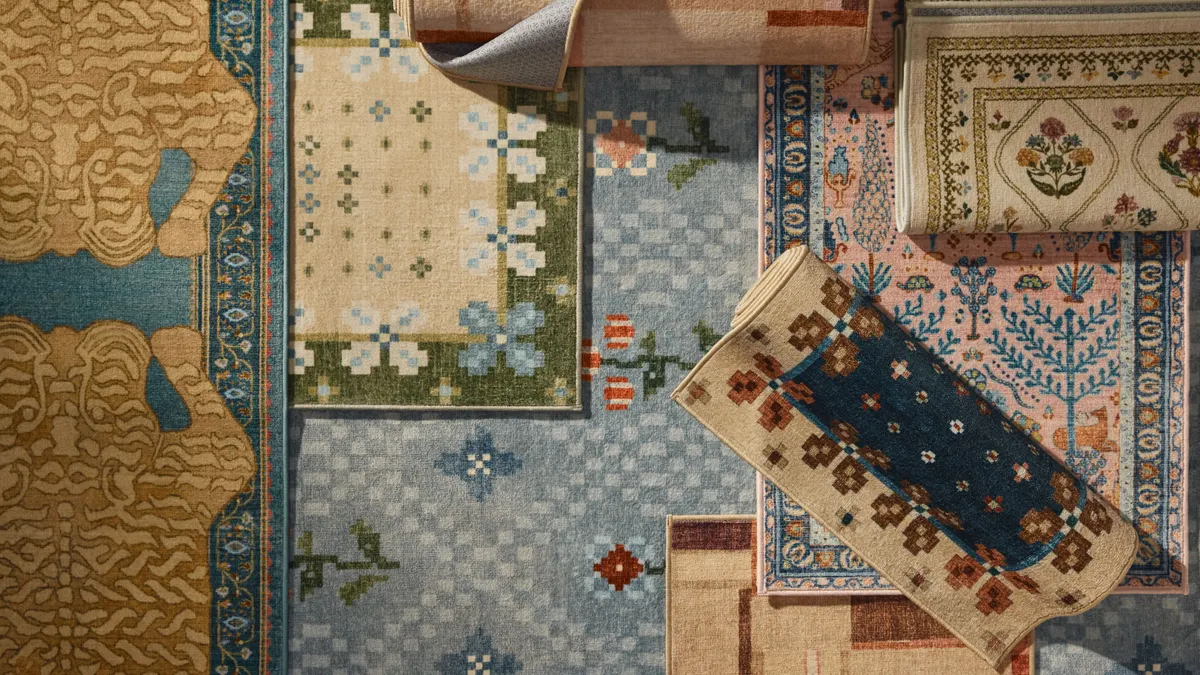 A selection of colorful rugs layered over one another.