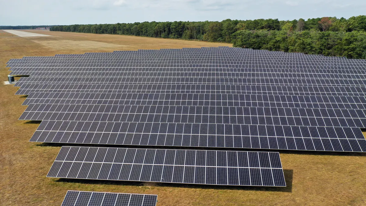 An array of solar panels in a field.
